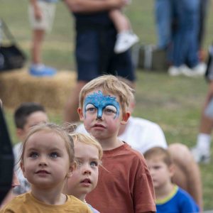 Child in festival crowd with Bleu Face paint as a deer