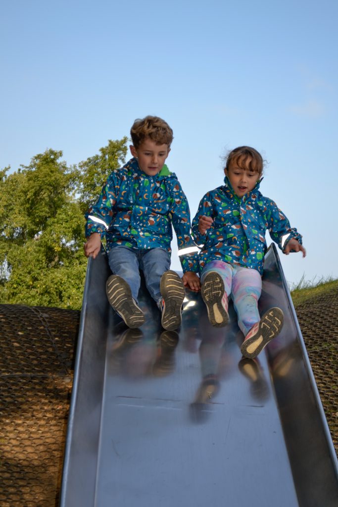 Children playing on a slide at Sky Park Farm during February half term