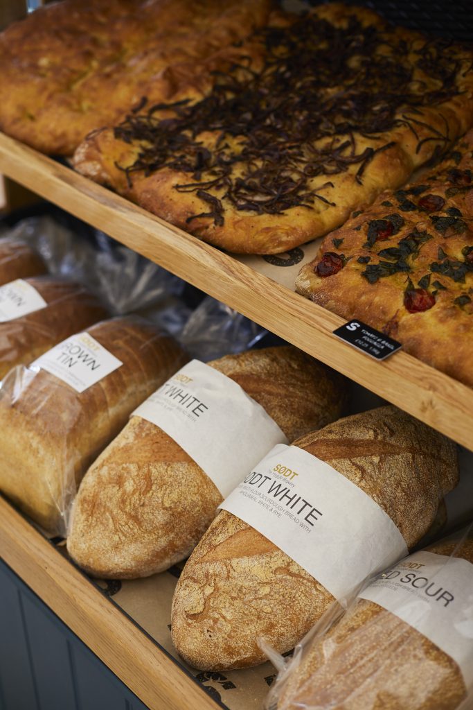 Sodt bakery bread and foccacia lining wooden shelves at the Sky Park Farm Shop