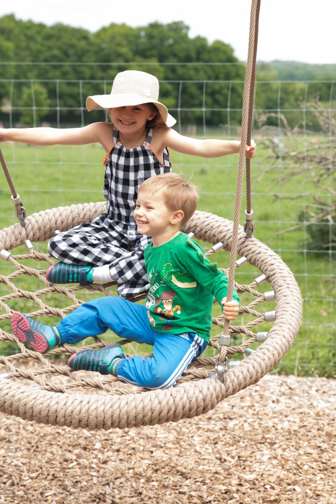 two children on rope swing