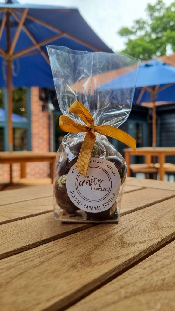 Chocolate truffle in a bag outside Sky Park Farm on a table